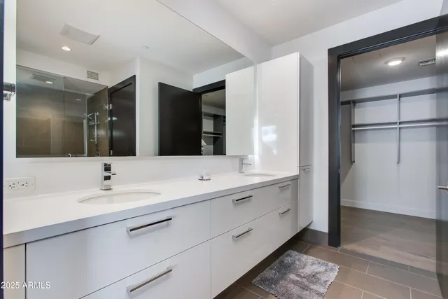 a bathroom with a double vanity sink and a mirror