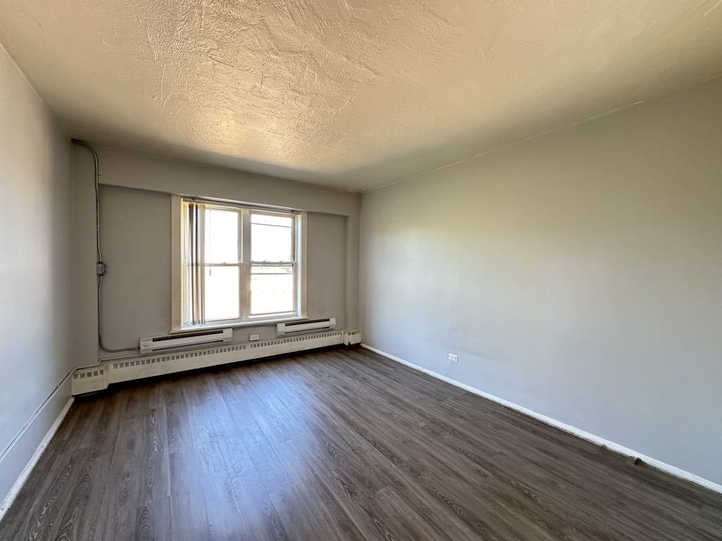 7333 North Ridge Boulevard, Unit 510 Chicago, IL 60645 - Photo 15 of 21 an empty room with wooden floor and windows