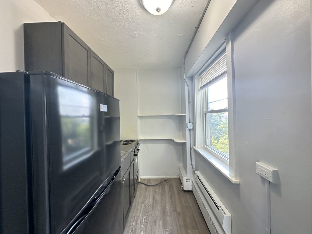 7333 North Ridge Boulevard, Unit 510 Chicago, IL 60645 - Photo 3 of 21 a kitchen with a wooden floor and a window