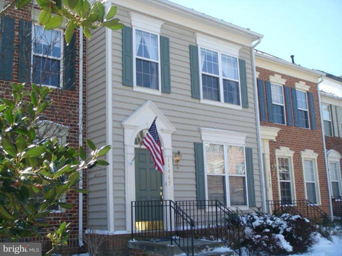 11467 Heritage Commons Way Reston, VA 20194 - Photo 1 of 19 a front view of a house with a garden