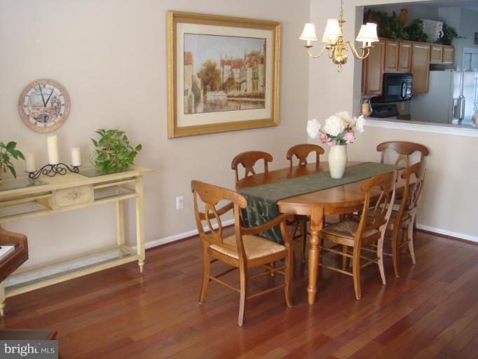 11467 Heritage Commons Way Reston, VA 20194 - Photo 11 of 19 a dining room with furniture and wooden floor