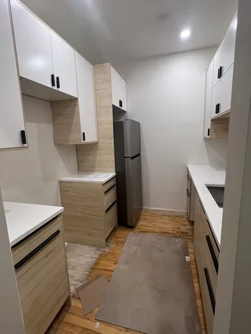 a kitchen with stainless steel appliances granite countertop a refrigerator and a stove