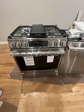 a stove top oven sitting inside of a kitchen