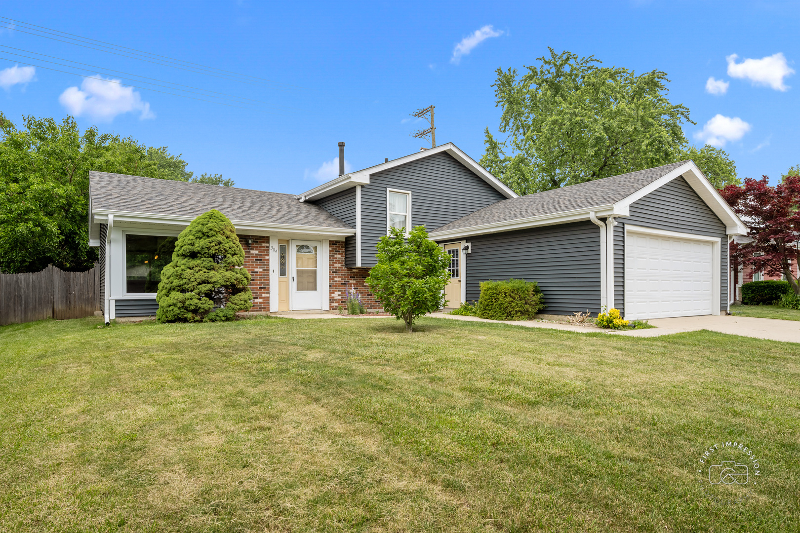 304 Dean Circle Bolingbrook, IL 60440 - Photo 2 of 23 a front view of house with yard and trees in the background