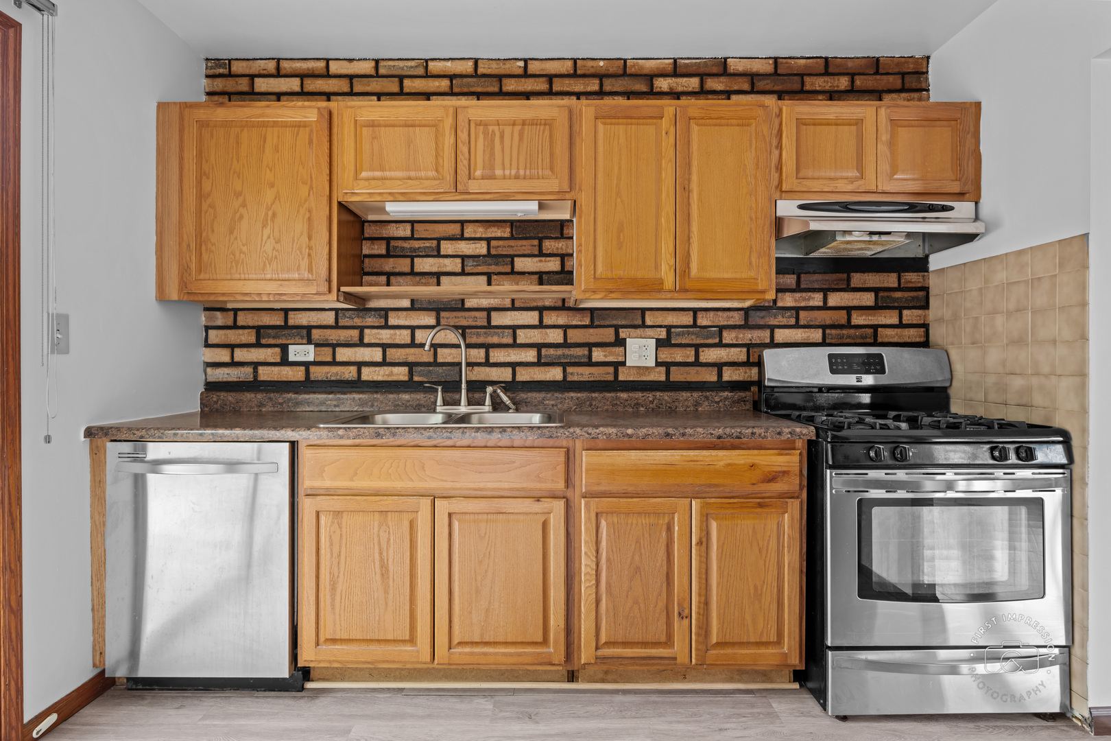 304 Dean Circle Bolingbrook, IL 60440 - Photo 7 of 23 a kitchen with stainless steel appliances granite countertop a stove a sink and a microwave