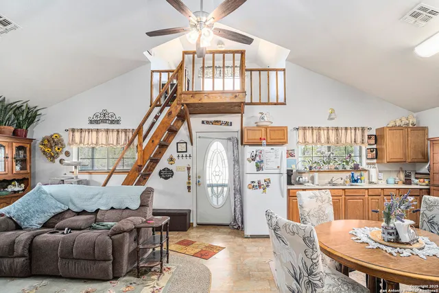 a living room with furniture a fireplace and a chandelier