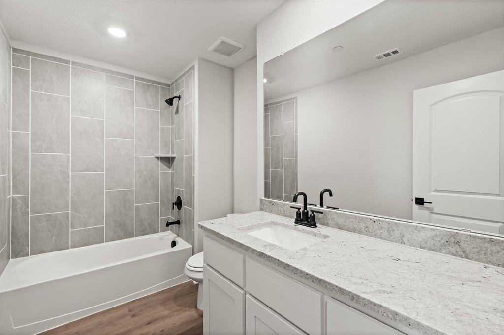 443 MB's Way Pilot Point, TX 76258 - Photo 7 of 8 a bathroom with a sink and a bathtub with a mirror