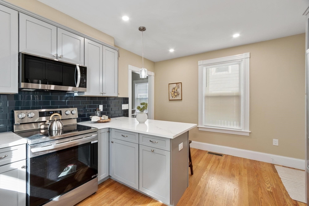 17 Buckingham Street, Unit 2 Somerville, MA 02143 - Photo 12 of 14 a kitchen with a sink stove and microwave