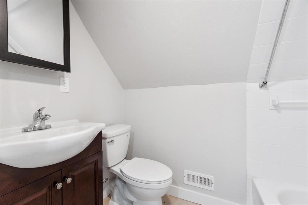 17 Buckingham Street, Unit 2 Somerville, MA 02143 - Photo 13 of 14 a bathroom with a sink a toilet and mirror