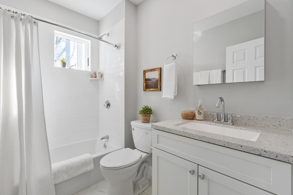 17 Buckingham Street, Unit 2 Somerville, MA 02143 - Photo 14 of 14 a bathroom with a granite countertop sink toilet and shower