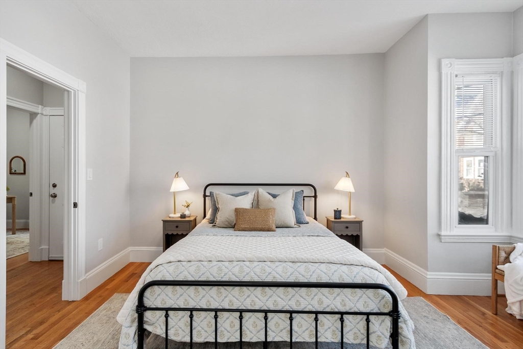 17 Buckingham Street, Unit 2 Somerville, MA 02143 - Photo 6 of 14 a bedroom with a bed and wooden floor