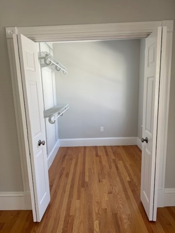 17 Buckingham Street, Unit 2 Somerville, MA 02143 - Photo 8 of 14 a view of walk in closet with wooden floor and door
