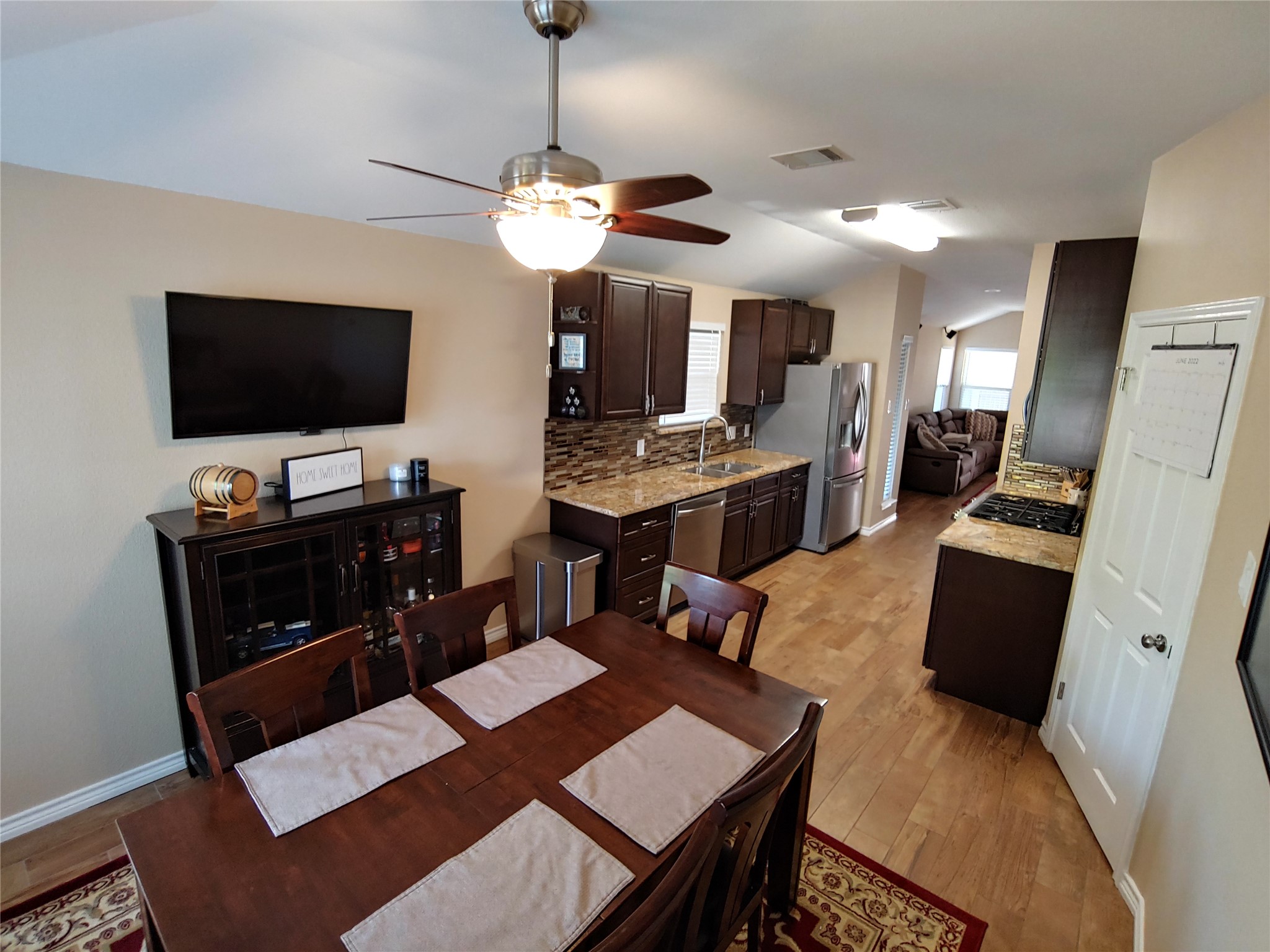 8124 Tockington Way Austin, TX 78748 - Photo 8 of 28 a view of a dining room with furniture and a flat screen tv