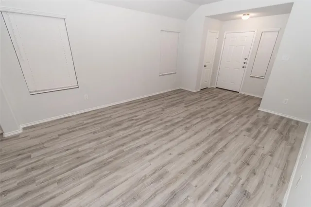 a view of room with wooden floor