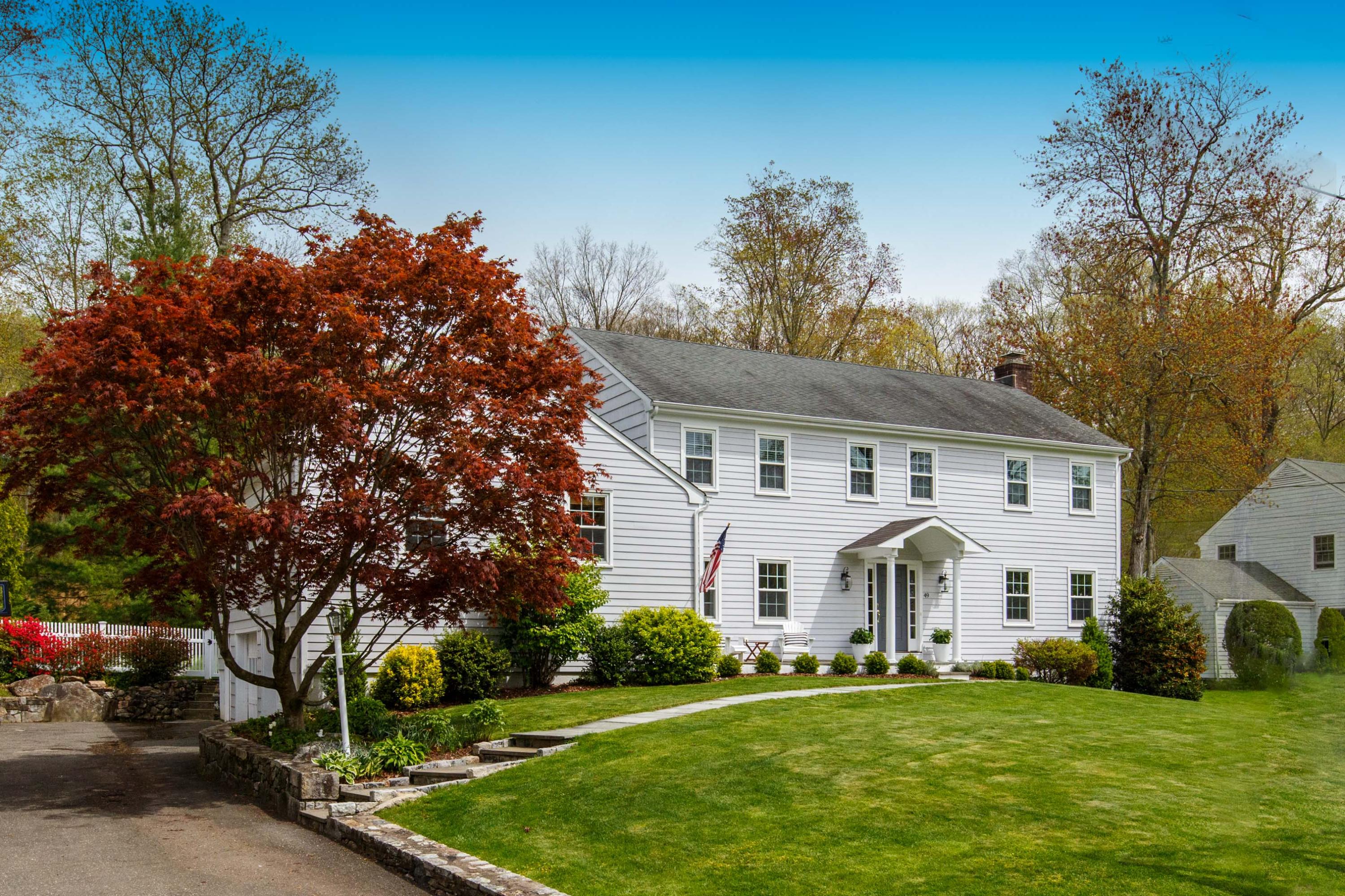 49 Country Club Road Darien, CT 06820 - Photo 1 of 30 a view of a white house with a big yard and large trees