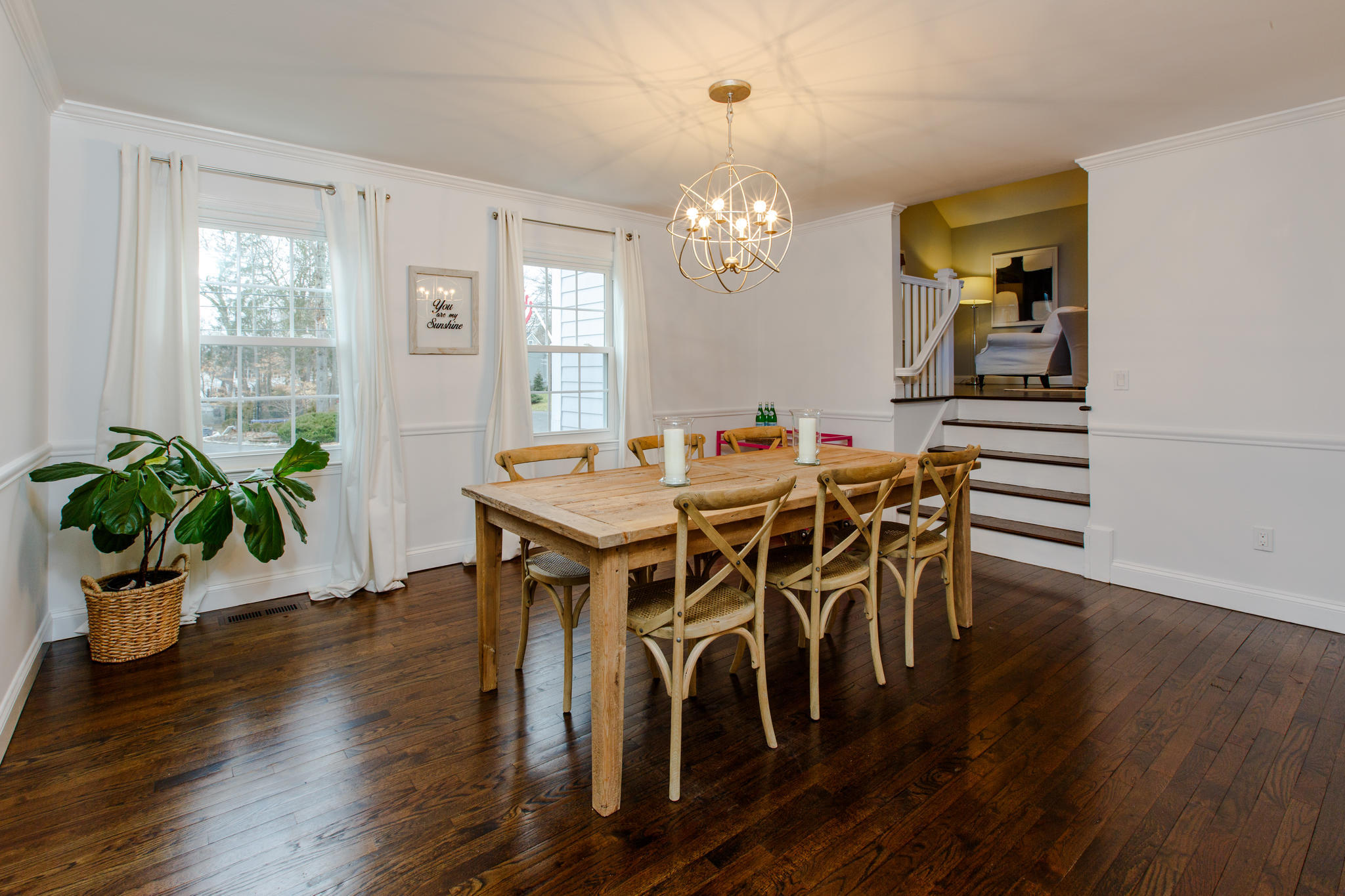 49 Country Club Road Darien, CT 06820 - Photo 12 of 30 a dining room with furniture potted plants and wooden floor