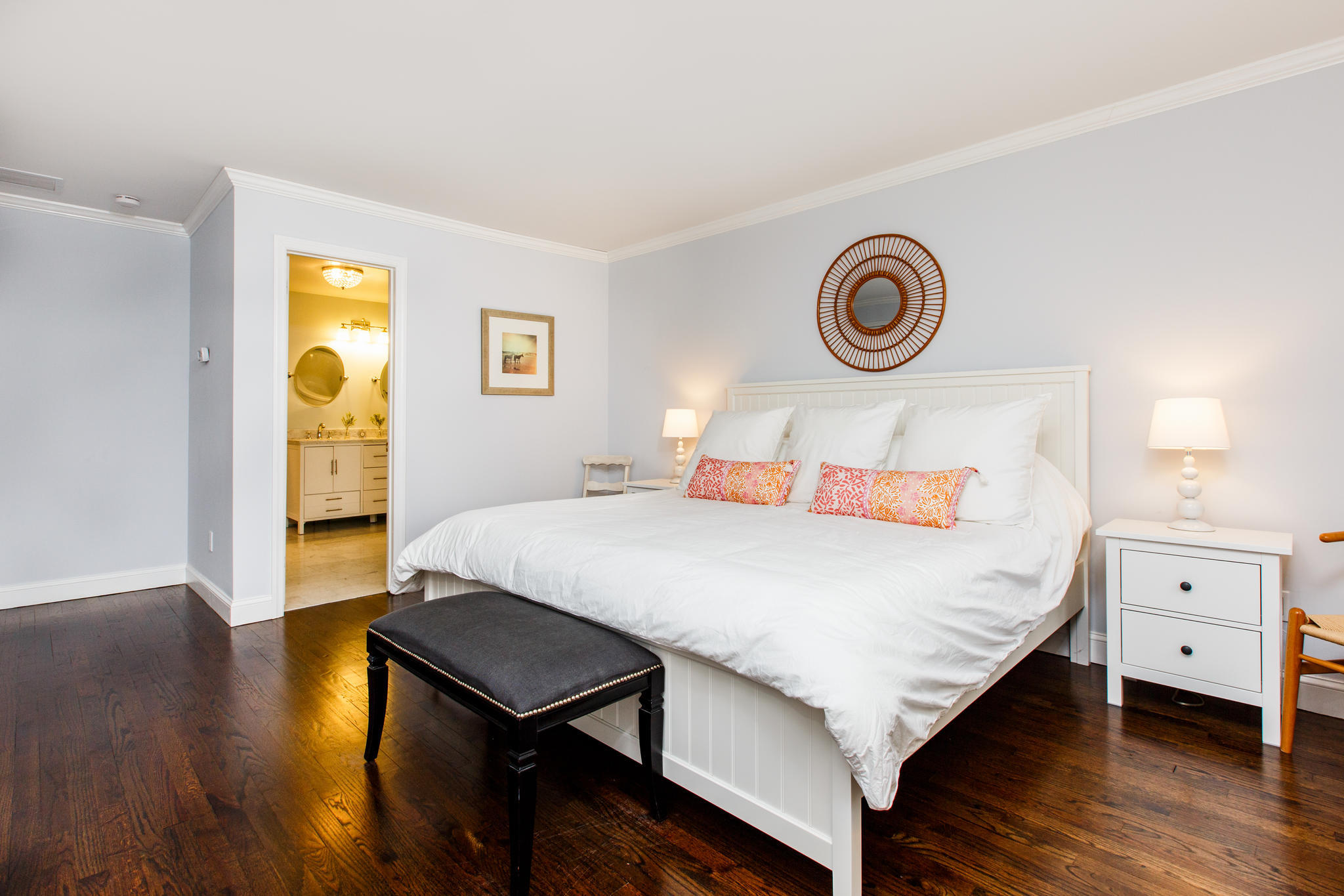 49 Country Club Road Darien, CT 06820 - Photo 20 of 30 a bedroom with a bed and a lamp on dresser with wooden floor