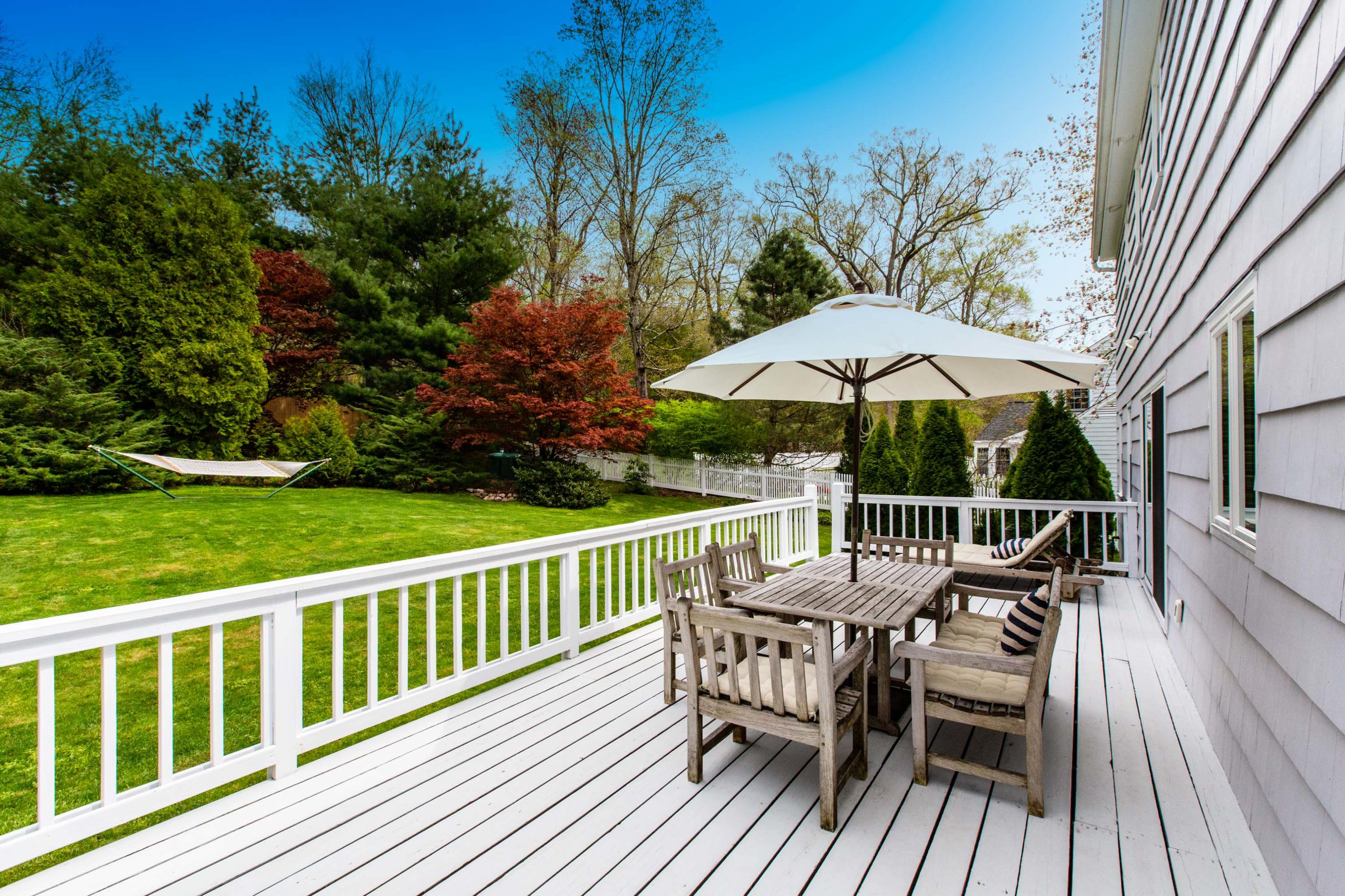49 Country Club Road Darien, CT 06820 - Photo 27 of 30 a view of a wooden deck with furniture