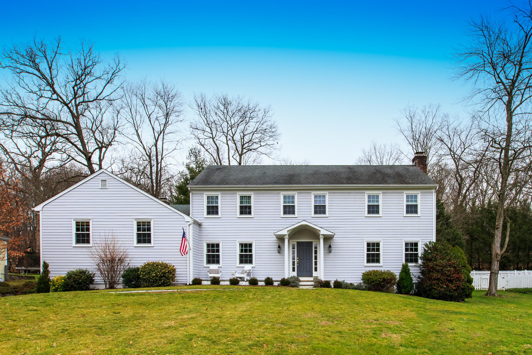 49 Country Club Road Darien, CT 06820 - Photo 30 of 30 a front view of house with yard and trees in the background
