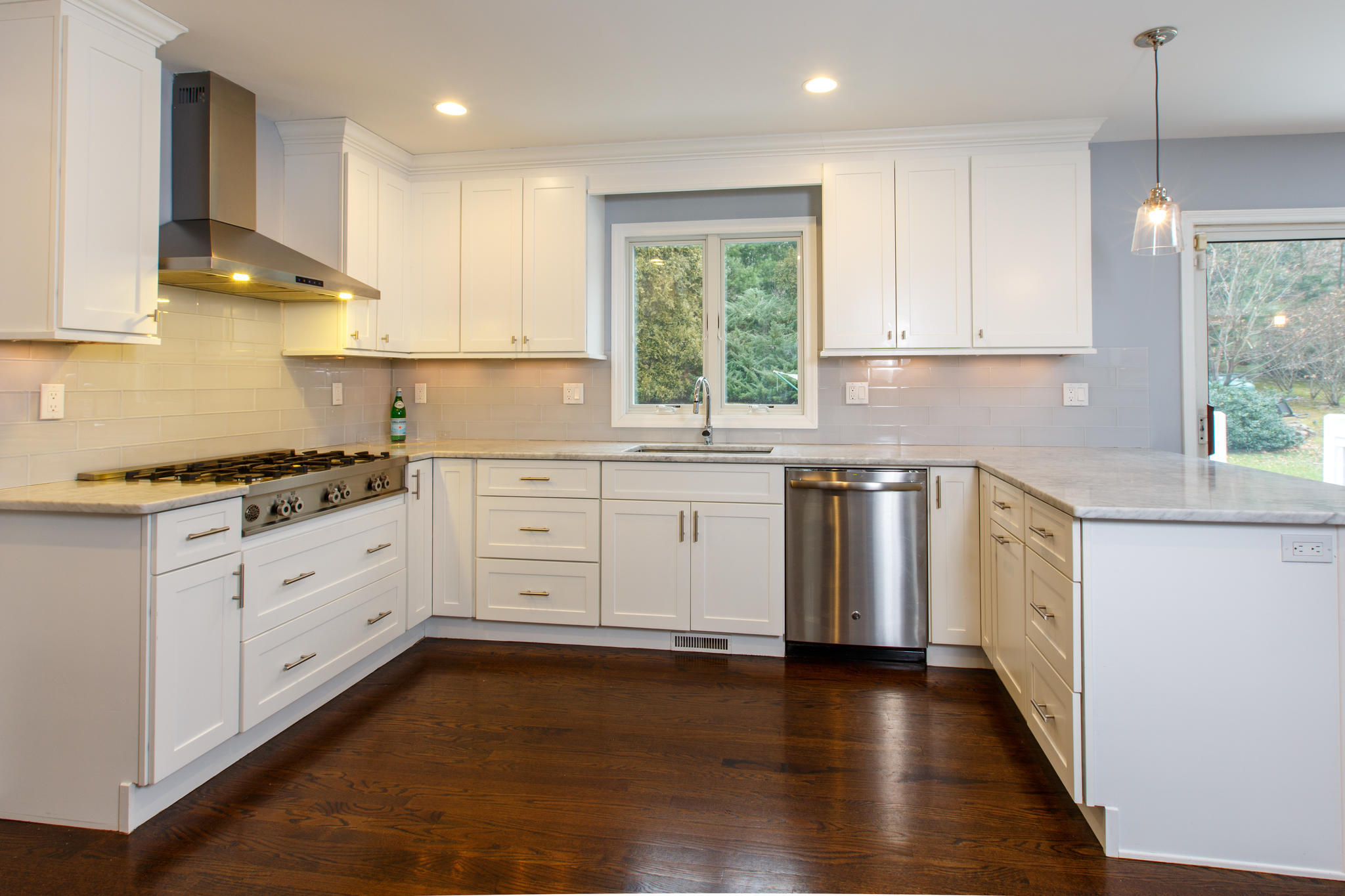 49 Country Club Road Darien, CT 06820 - Photo 10 of 30 a kitchen with granite countertop white cabinets sink and stainless steel appliances