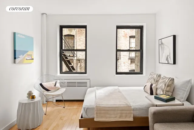 a bedroom with bed and window