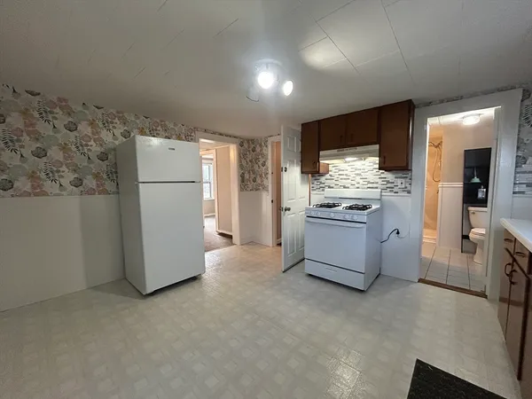 a kitchen with a refrigerator and a stove