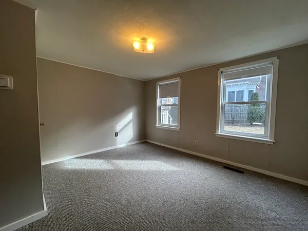 a view of an empty room with windows