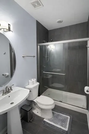 a white toilet sitting next to a bathroom sink