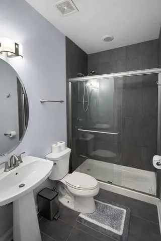 a white toilet sitting next to a bathroom sink
