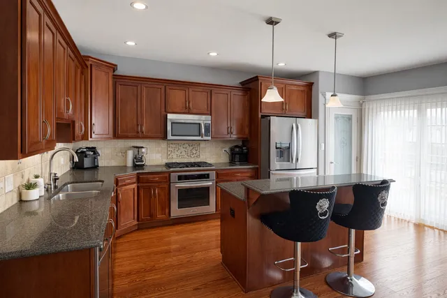 a kitchen with granite countertop a sink cabinets and window
