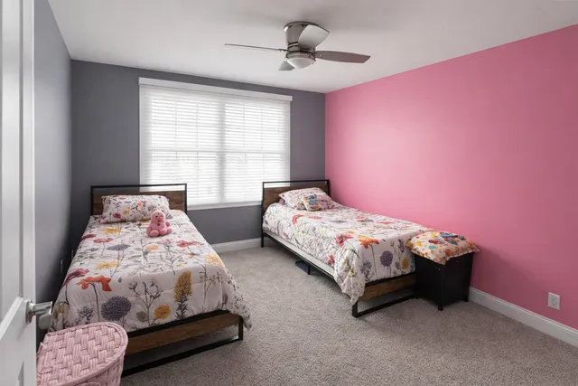 a bedroom with bed and a window