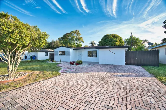 a front view of a house with a yard and a garage