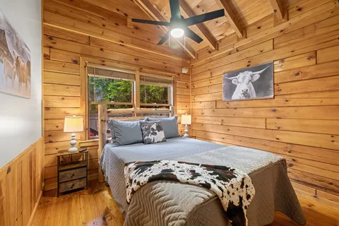 a bed sitting in a bedroom next to a window