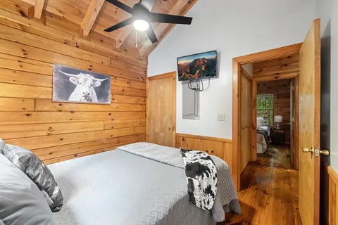 a bedroom with a bed and a painting on the wall