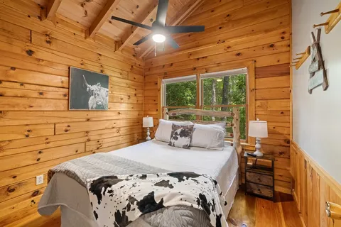 a bedroom with a bed and a wooden floor