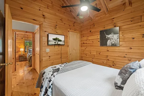 a bedroom with a bed and a wall painting