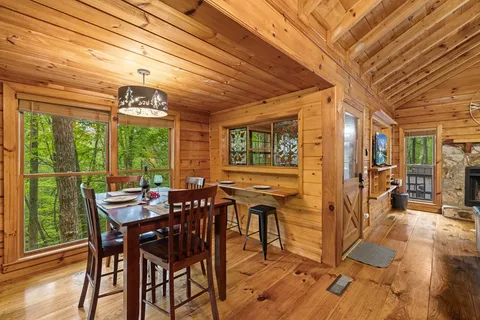 a view of a dining room with furniture window and wooden floor