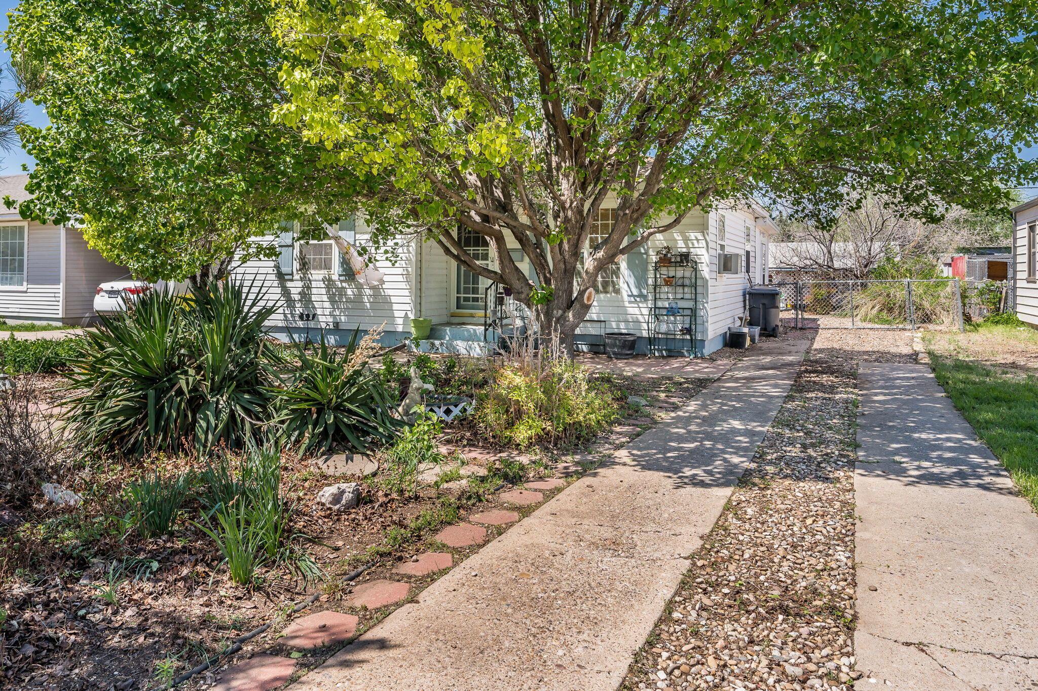 4204 Gables Street Amarillo, TX 79110 - Photo 1 of 19 a front view of a house with a garden