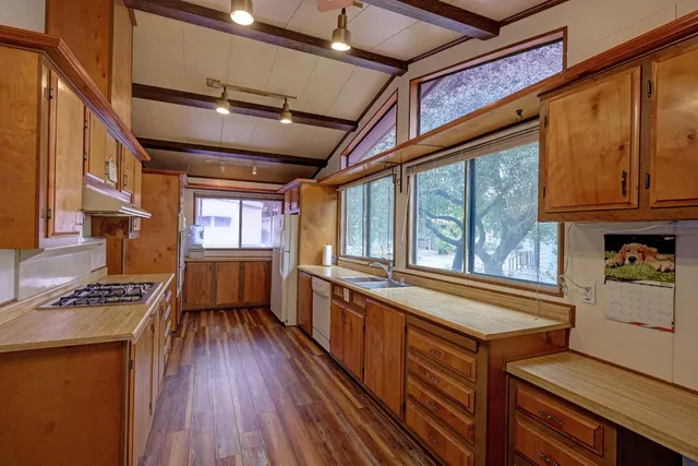a open kitchen with stainless steel appliances granite countertop a stove and cabinets