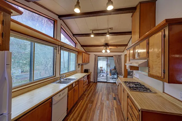 a kitchen with stainless steel appliances granite countertop a stove and a wooden cabinets