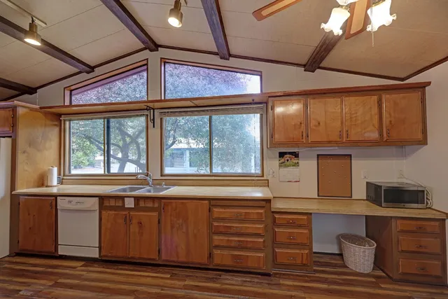 a kitchen with wooden floors and a sink