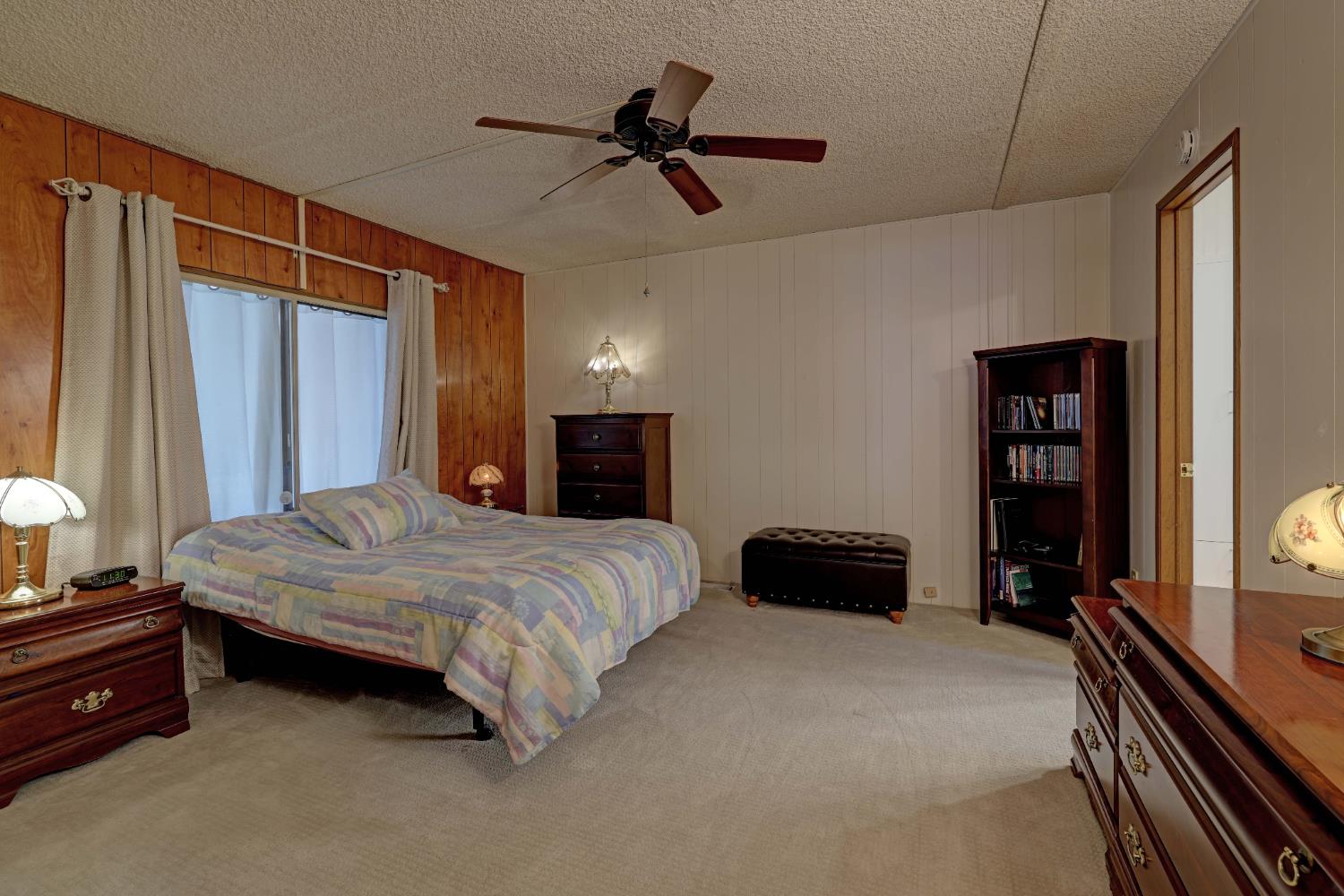 3765 Grass Valley Highway, Unit 263 Auburn, CA 95602 - Photo 21 of 38 a bedroom with a bed and a chandelier