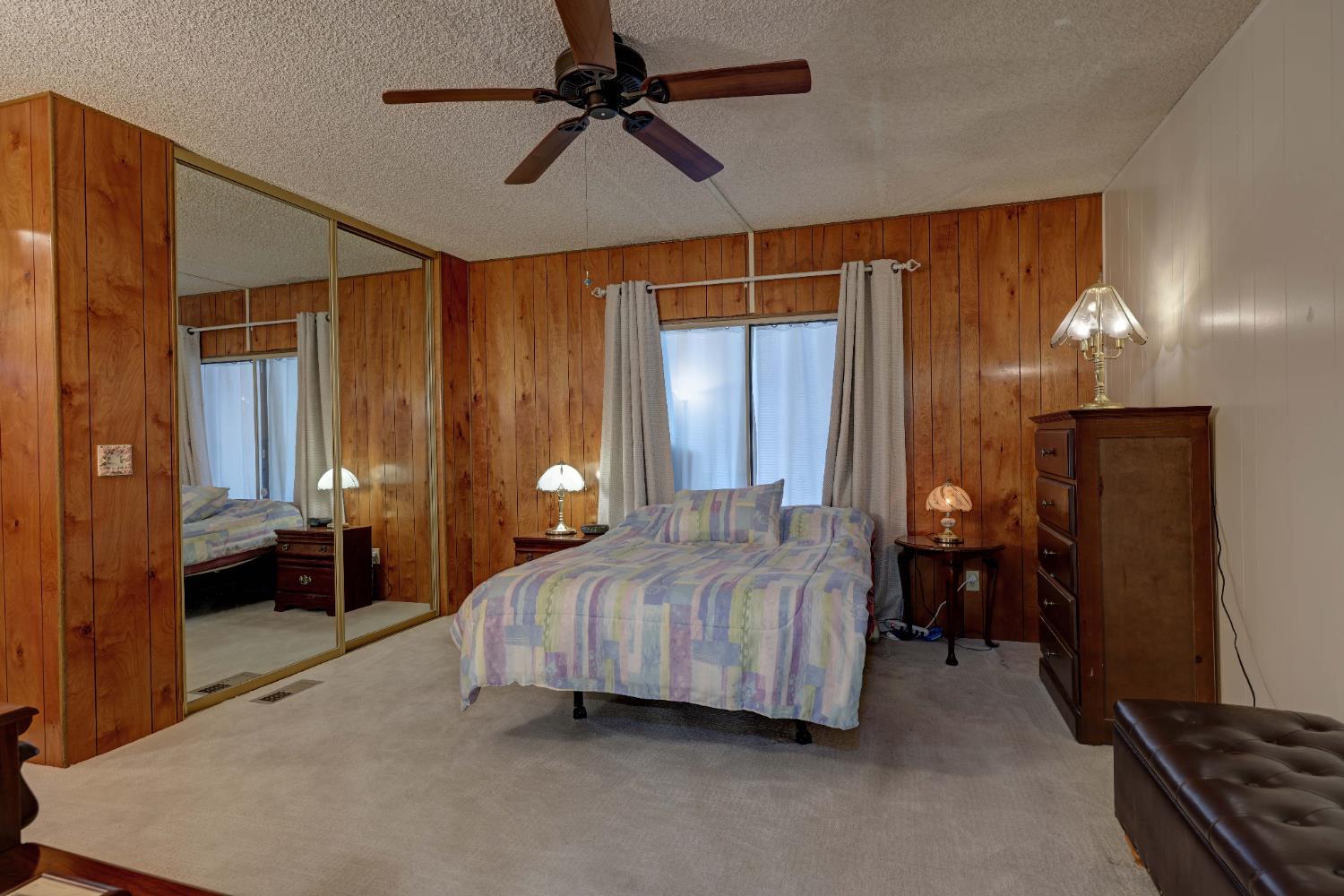 3765 Grass Valley Highway, Unit 263 Auburn, CA 95602 - Photo 22 of 38 a bedroom with a bed and a chandelier