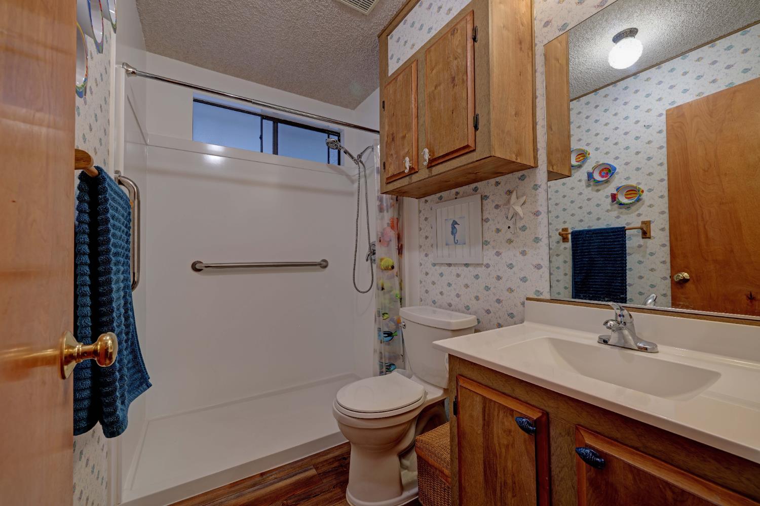 3765 Grass Valley Highway, Unit 263 Auburn, CA 95602 - Photo 26 of 38 a bathroom with a sink a toilet and shower