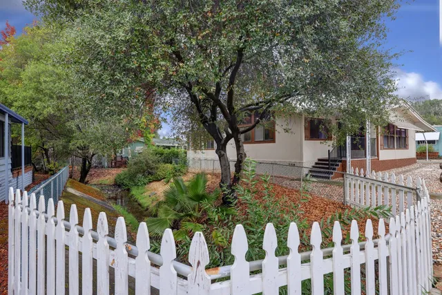 a view of a house with wooden fence