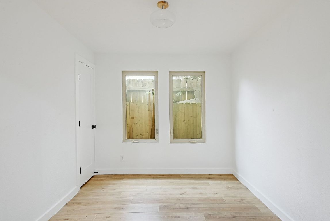 2404 Santa Rita Street Austin, TX 78702 - Photo 14 of 27 Spare room with light wood-style flooring and baseboards