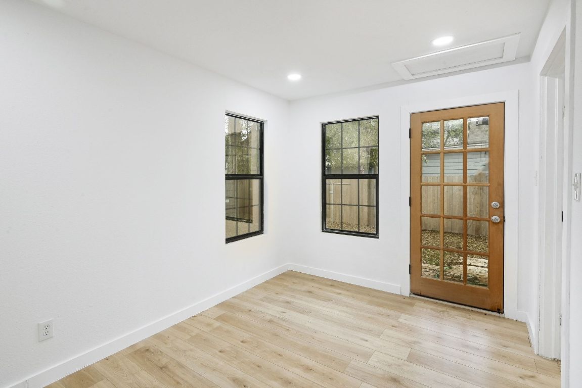 2404 Santa Rita Street Austin, TX 78702 - Photo 17 of 27 Empty room featuring light wood-type flooring, attic access, and recessed lighting