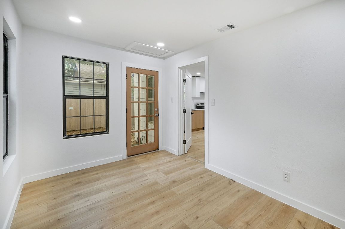 2404 Santa Rita Street Austin, TX 78702 - Photo 18 of 27 Empty room with light wood-style floors, recessed lighting, and attic access