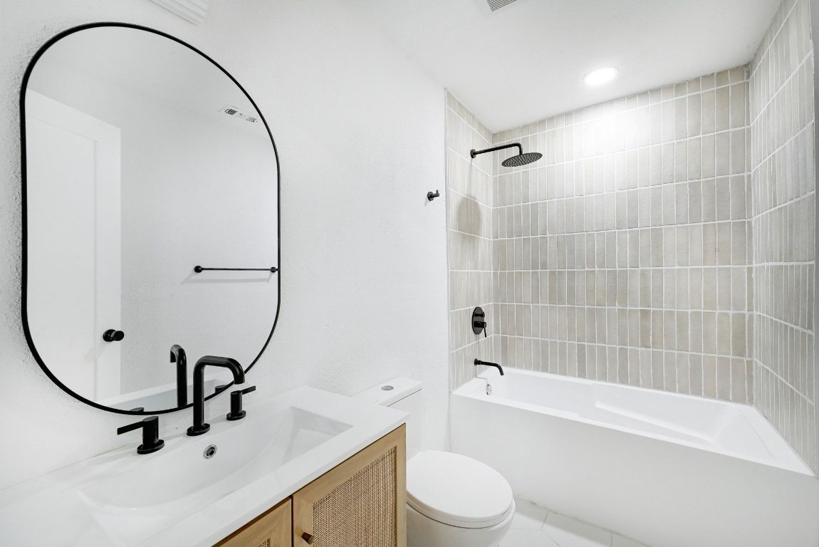 2404 Santa Rita Street Austin, TX 78702 - Photo 19 of 27 Full bathroom featuring bathing tub / shower combination and vanity