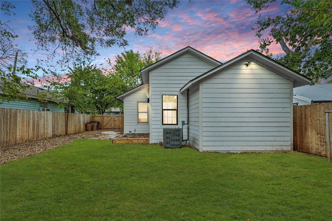 2404 Santa Rita Street Austin, TX 78702 - Photo 22 of 27 Back of property at dusk with a fenced backyard